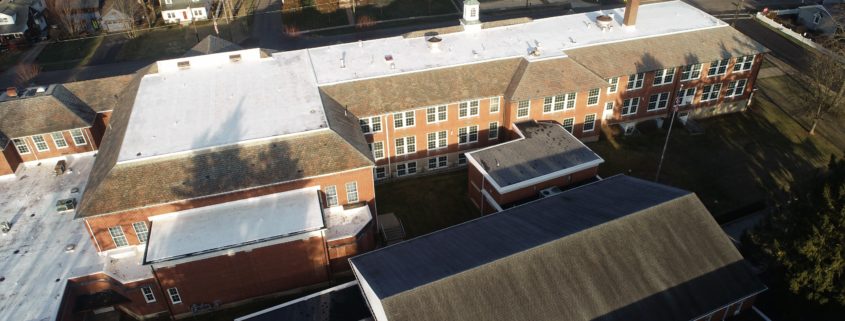 School roof undergoing service with TEMA Roofing.