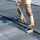 Roofing contractor performing commercial roof installation.
