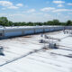 A commercial roof with drops in its roofing material that requires sagging roof repair.