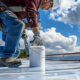 A roofing contractor applying a commercial roof coating.