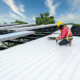 Professional roofers during a commercial roof replacement.