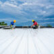 Professional roofers installing a commercial roof.