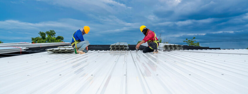 Professional roofers installing a commercial roof.