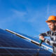 Professional roofers installing commercial solar panels.