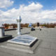 Commercial roof with multiple vents that is protected by roof leak service agreement