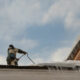 Removing snow on a commercial roof.