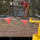 Commercial roofers performing a roof replacement project.