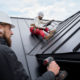 Roofers performing a common commercial roof repair.