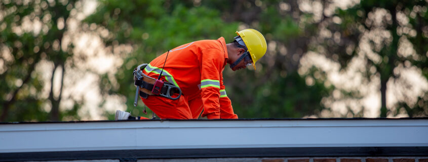Roofers performing emergency commercial roof repair.