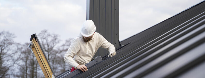 Roofing company installing a metal roofing system.