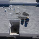 Commercial roofers performing roof maintenance.