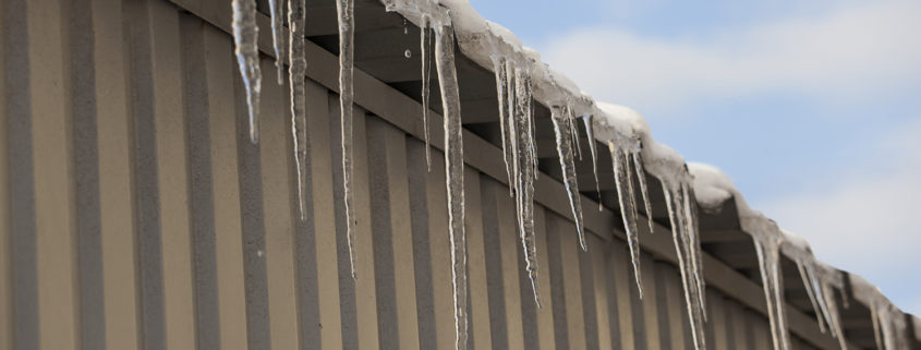Commercial roof damage caused by ice and snow.
