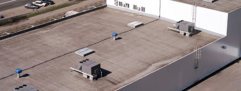 Roof of a commercial building with a external units of the commercial air conditioning and ventilation systems