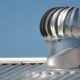 Metal roof vent on metal commercial roof.