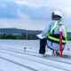 A commercial roofer conducting a roof inspection.