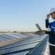 A contractor checking commercial solar panel efficiency.