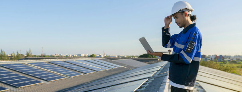 A contractor checking commercial solar panel efficiency.